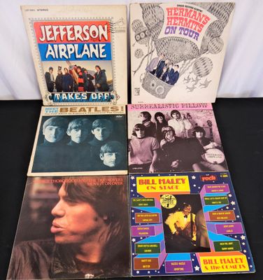 a group of records including jefferson airplane, the beatles, the beatles, and the beatles