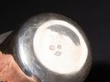 a person holding a metal object with a smiley face on it