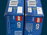 two boxes of legos sitting on top of each other