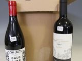 two bottles of wine sitting next to each other in a box
