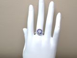 a white hand with a blue and white ring on it