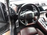 the interior of a car with a steering wheel, dashboard and dashboard controls