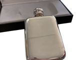 an image of a silver flaskt in a box with its lid open