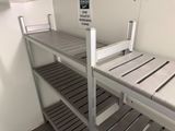 a bunk bed in a room with a sign on the wall