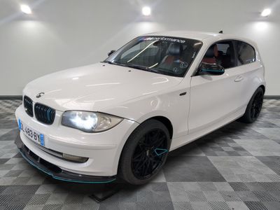 a picture of a white bmw car in a showroom