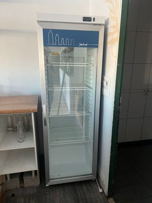 un réfrigérateur qui se trouve dans le coin d'une pièce