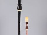 an image of a black and white flute and a brown and white flute