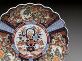 a decorative plate with flowers and birds on it