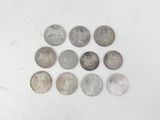 six different types of coins are arranged in a circle on a white surface