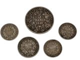 a group of five coins with the names of different countries on them