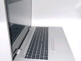 a silver laptop with a black keyboard on a white surface