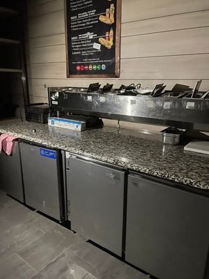 a picture of a restaurant counter with a bunch of dishes on it