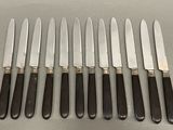 six knives are lined up next to each other on a table