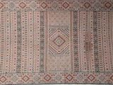 an image of a rug on a bed with a red border