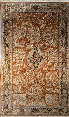 an orange and black rug with a medallion design on it