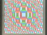 painting of a multicolored geometric design in a frame on a wall
