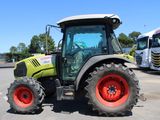 a tractor that is parked next to a bus in a parking lot