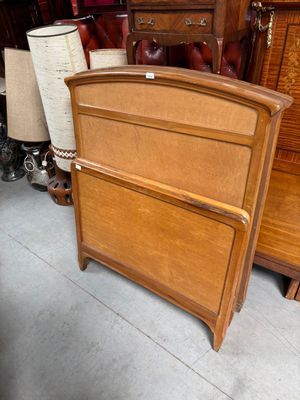 a bed with a wooden headboard and foot board in a room
