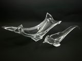 pair of clear glass birds on a black background