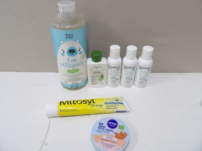 a toothbrush, toothpaste, toothpaste, and toothpaste on a table