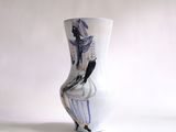 a white vase with a picture of a woman on it