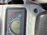 a close up of a motorcycle with a speedometer on it ' s dashboard