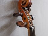 a violin that is leaning against a wall