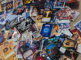 a pile of cards on the floor next to a laptop