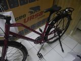 a red bike that is parked in a room