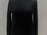 black sweater with blue trims on a mannequin base