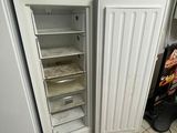 an open refrigerator in the corner of a kitchen