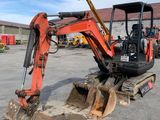 a small excavator that is parked in a parking lot
