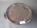 a silver plate on a table with a tag on it