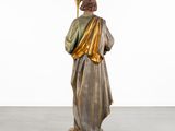 an image of a statue of a man holding a staff