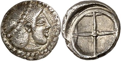 a silver coin with an image of a man ' s face on it