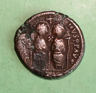 a close up of a coin with a man and a woman on it