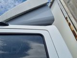 a white truck with a flat bed sitting in a parking lot