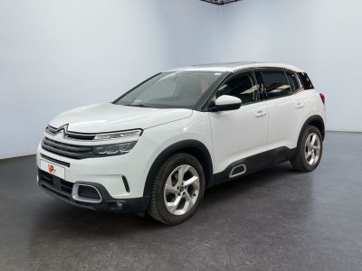 the white citrole is parked in a large room