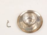 a silver plate with a hook on it next to a chain