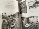 an open book with pictures of people working in a factory