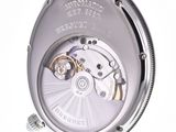 a close up of a watch on a white surface