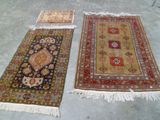 three oriental rugs on the floor in a room
