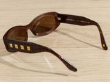 a pair of sunglasses sitting on a wooden table