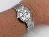 a woman ' s wrist that has a watch on it