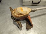 a metal object with a wooden handle on a table