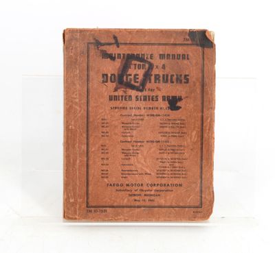 an old brown book sitting on top of a white table