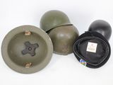 three military helmets are lined up on a white surface