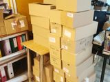 many boxes stacked on top of each other in a room