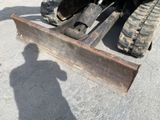 a tractor with a plow attached to it ' s back end