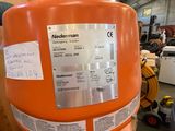 an orange tank with a hose attached to it in a warehouse